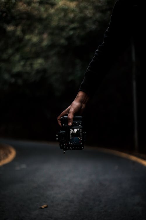 A Person Holding a DSLR Camera