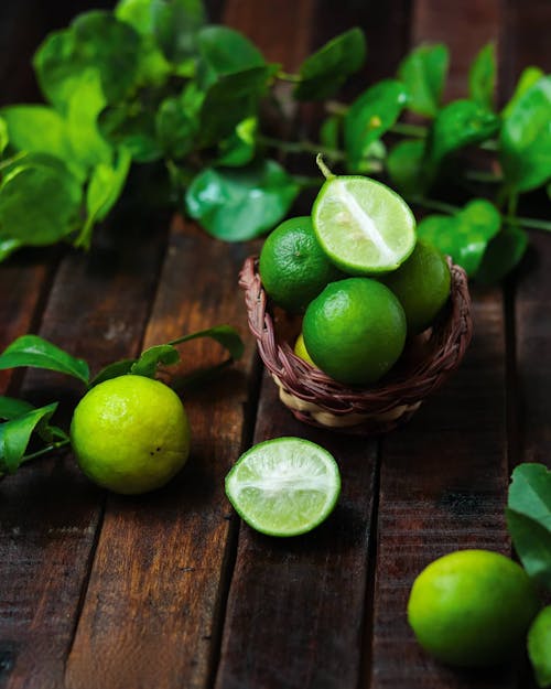 Close-Up Shot of Limes on a Wooden Surface