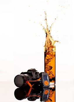 Black Canon Dslr Camera Behind Clear Highball Glass