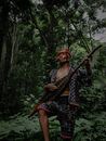 A Man Playing a String Instrument in a Forest