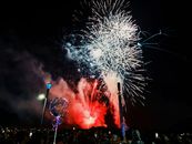 Crowd enjoying a vibrant fireworks show at night in Atlantic City.