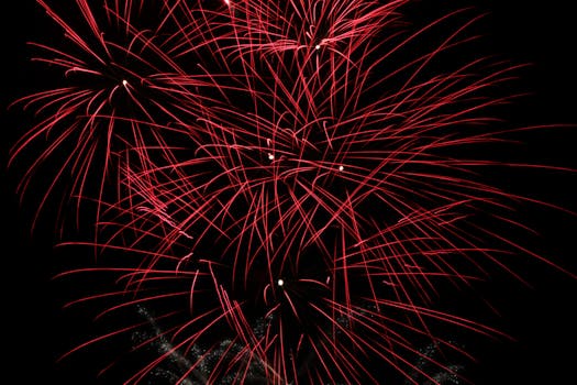 A vivid display of red fireworks lighting up the night sky, perfect for celebrations and festive occasions.