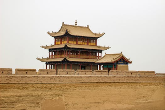 Iconic Jiayu Pass pagoda with cloudy sky, highlighting historic architecture.