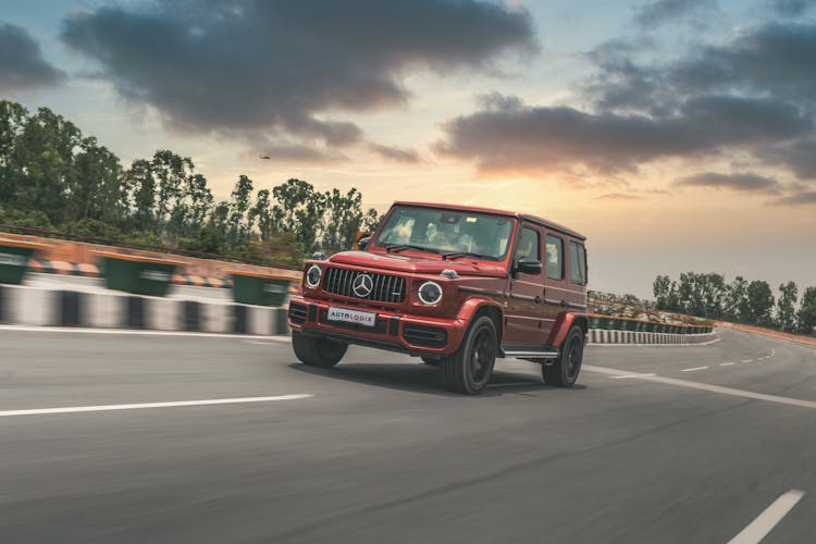 Red Luxury SUV Driving On The Road