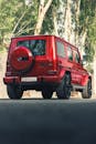 Red and Black Suv on Road