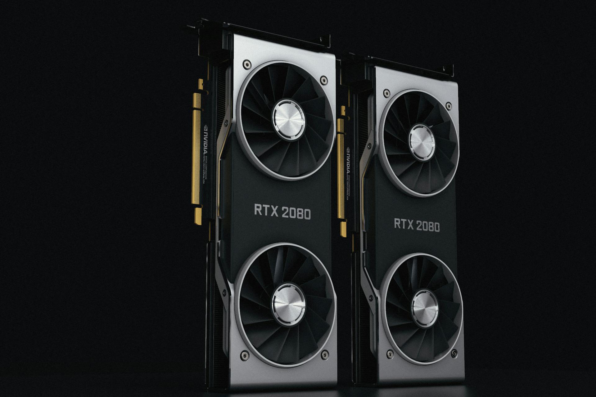 Close-up of two NVIDIA RTX 2080 graphics cards with dual fans, high-performance hardware.