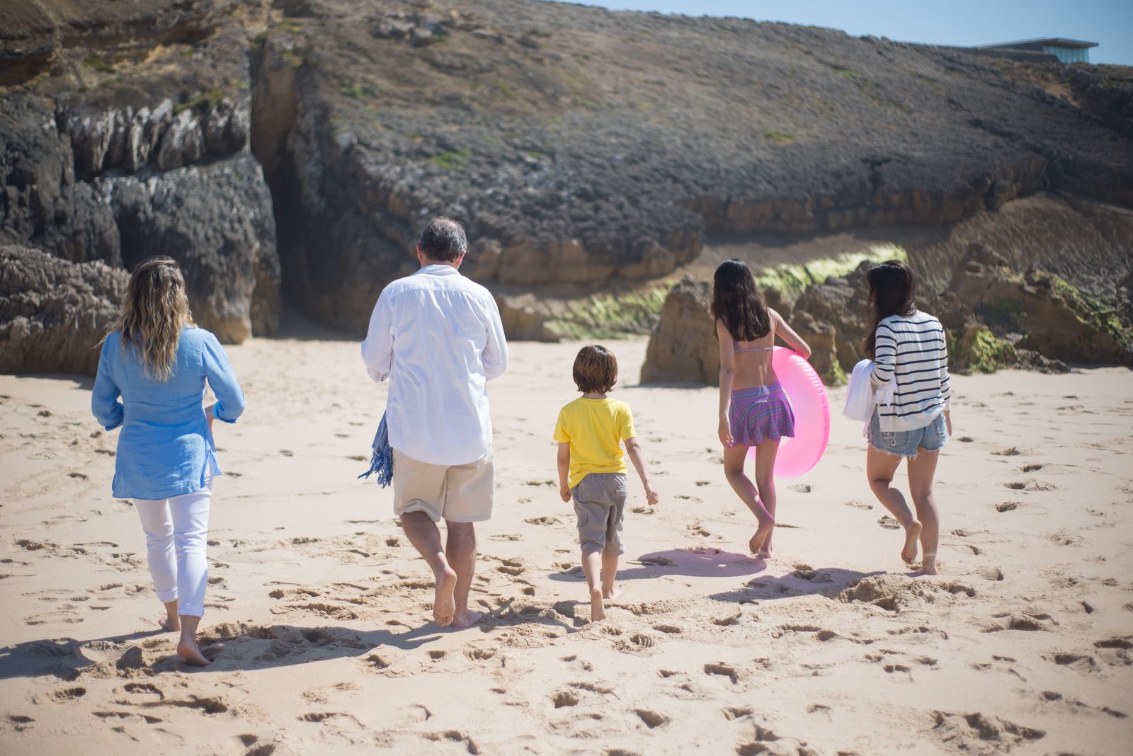 Travellers walking on a sunny beach in Portugal