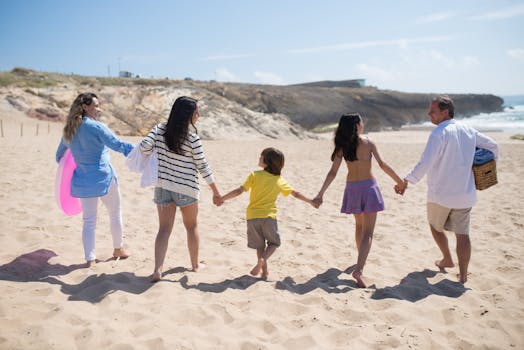 Family enjoying a sunny day at the beach in Portugal, walking hand in hand on the sand.
