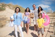 Group of People Standing on Brown Sand