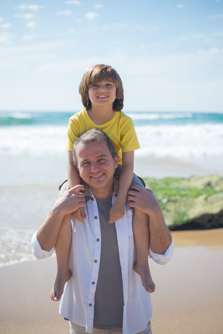 A Father Carrying His Kid On His Shoulders