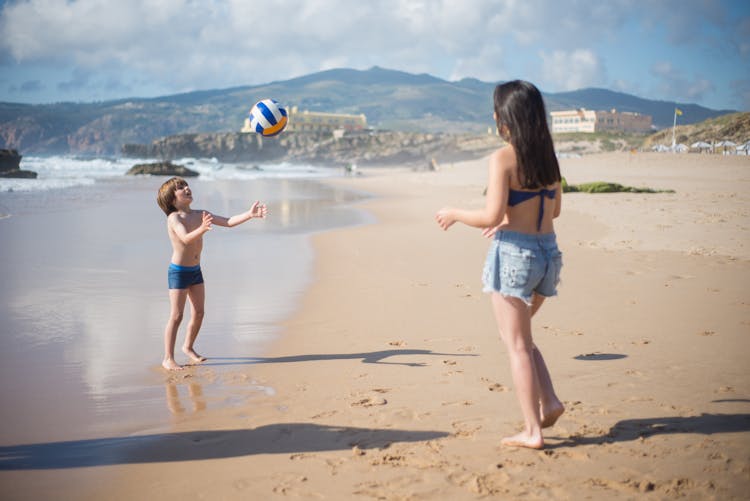 A Young Boy Playing A Volleyball