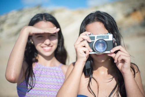 Woman in Blue Bikini Holding a Camera