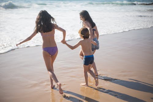 Three Children Having Fun on the Beach