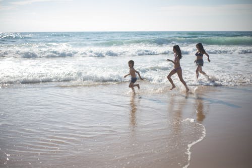 Free People Running on the Beach Stock Photo