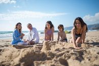 A Family Hanging Out Building a Sand Castle on the Beach