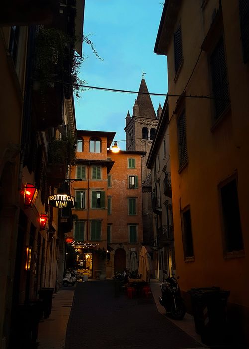 Free A picturesque alley in Verona, Italy, captured at twilight with warm lighting and classic architecture. Stock Photo