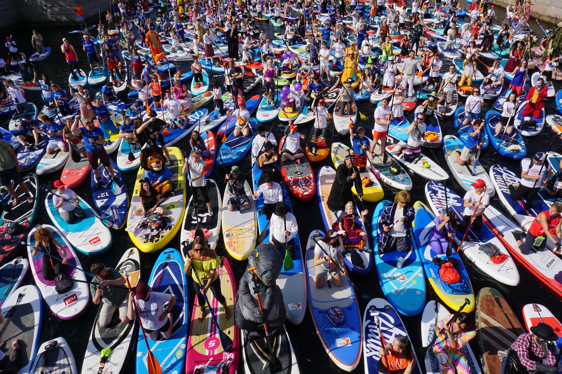 A vibrant aerial shot of paddleboarders gathering for a festival in Saint Petersburg, Russia.