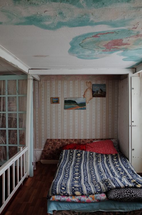 Bedroom ceiling showing water stains near the light fixture