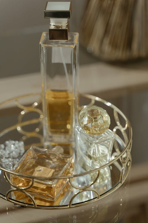Free Clear Glass Perfume Bottles on a Round Tray Stock Photo