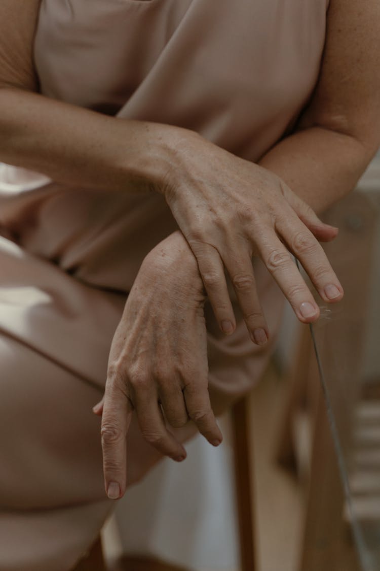 A Woman's Hand Touching A Glass Table