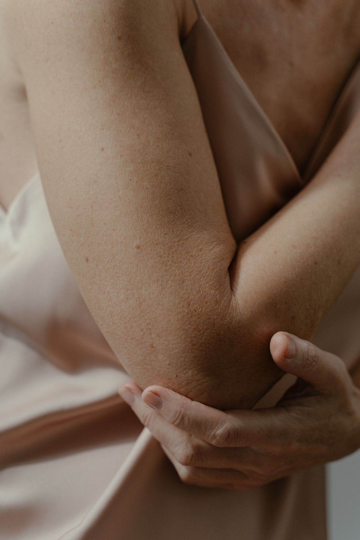 Person gripping their elbow in discomfort