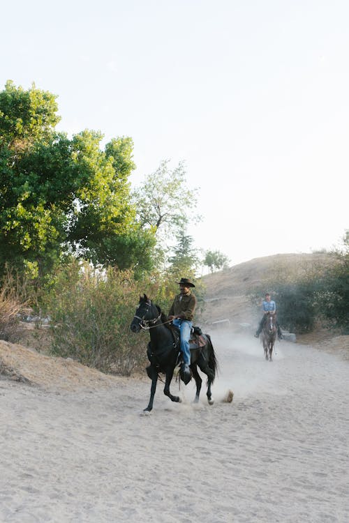 A Man and a Woman Riding Horses