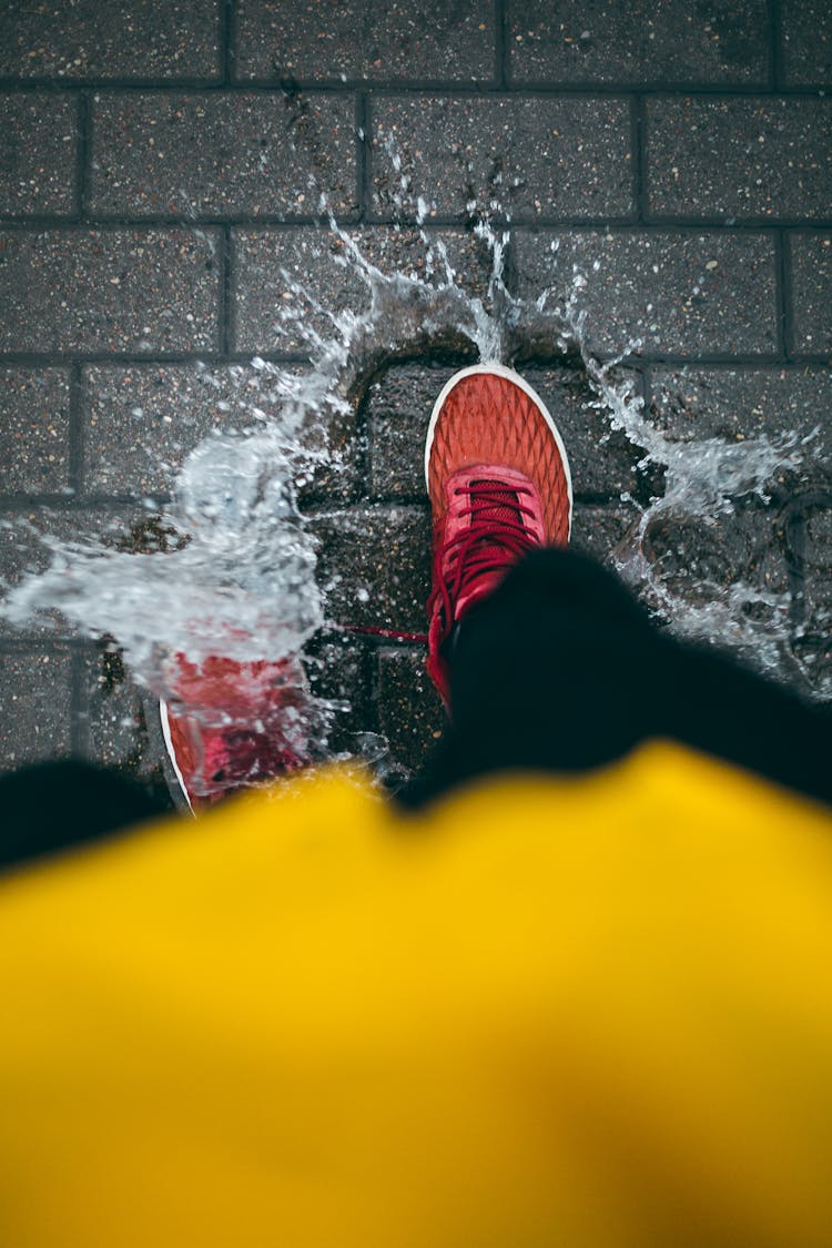 A Person Stepping On A Puddle 