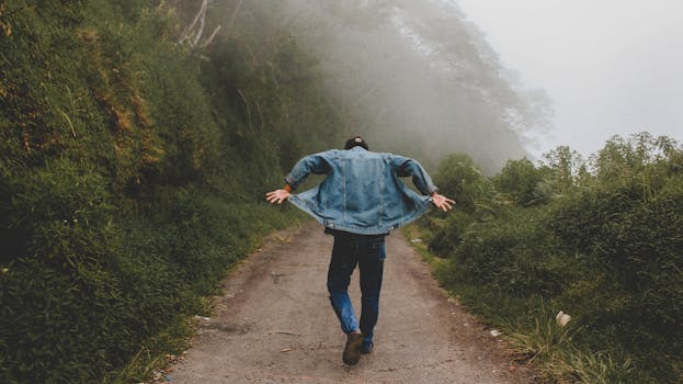 Person Wearing Blue Denim Jacket While Walking on Foggy Road - Boohoo