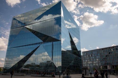 Modern Glass Building under Cloudy Sky 