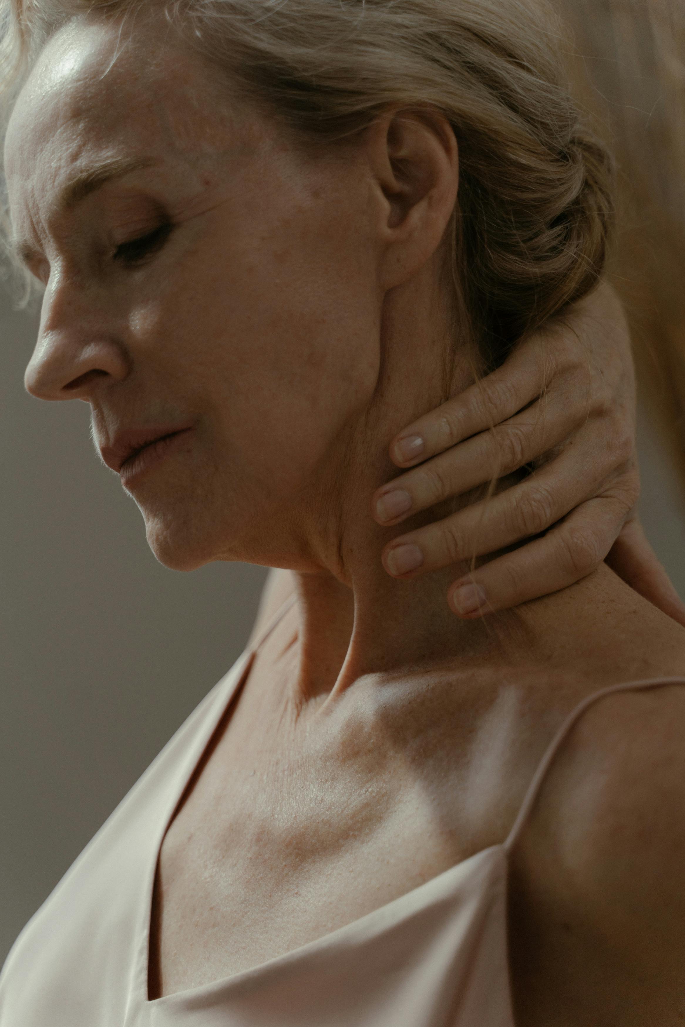 Woman Holding her Neck · Free Stock Photo