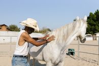 Horseman petting his Horse
