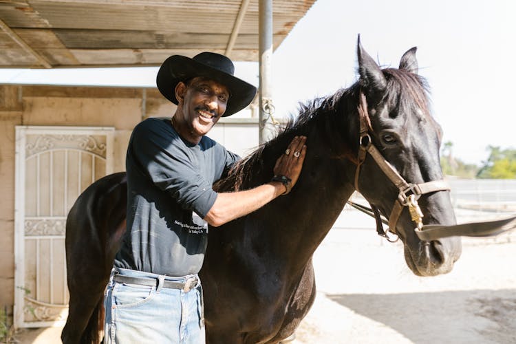 A Man Petting A Horse 