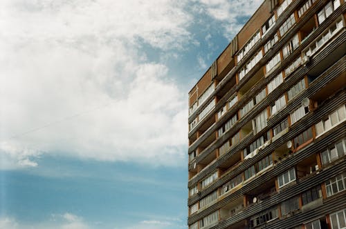 Free Facade of an Apartment Building against Cloudy Sky  Stock Photo
