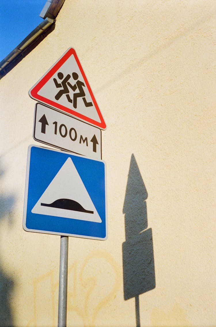 Road Signs On White Wall Background