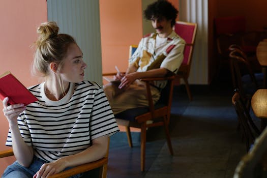 A man and woman sitting in a cozy café, each absorbed in their books and thoughts.