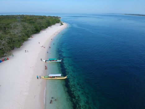 Discover the serene white sand beach and vibrant blue waters of Zamboanga, captured from above.