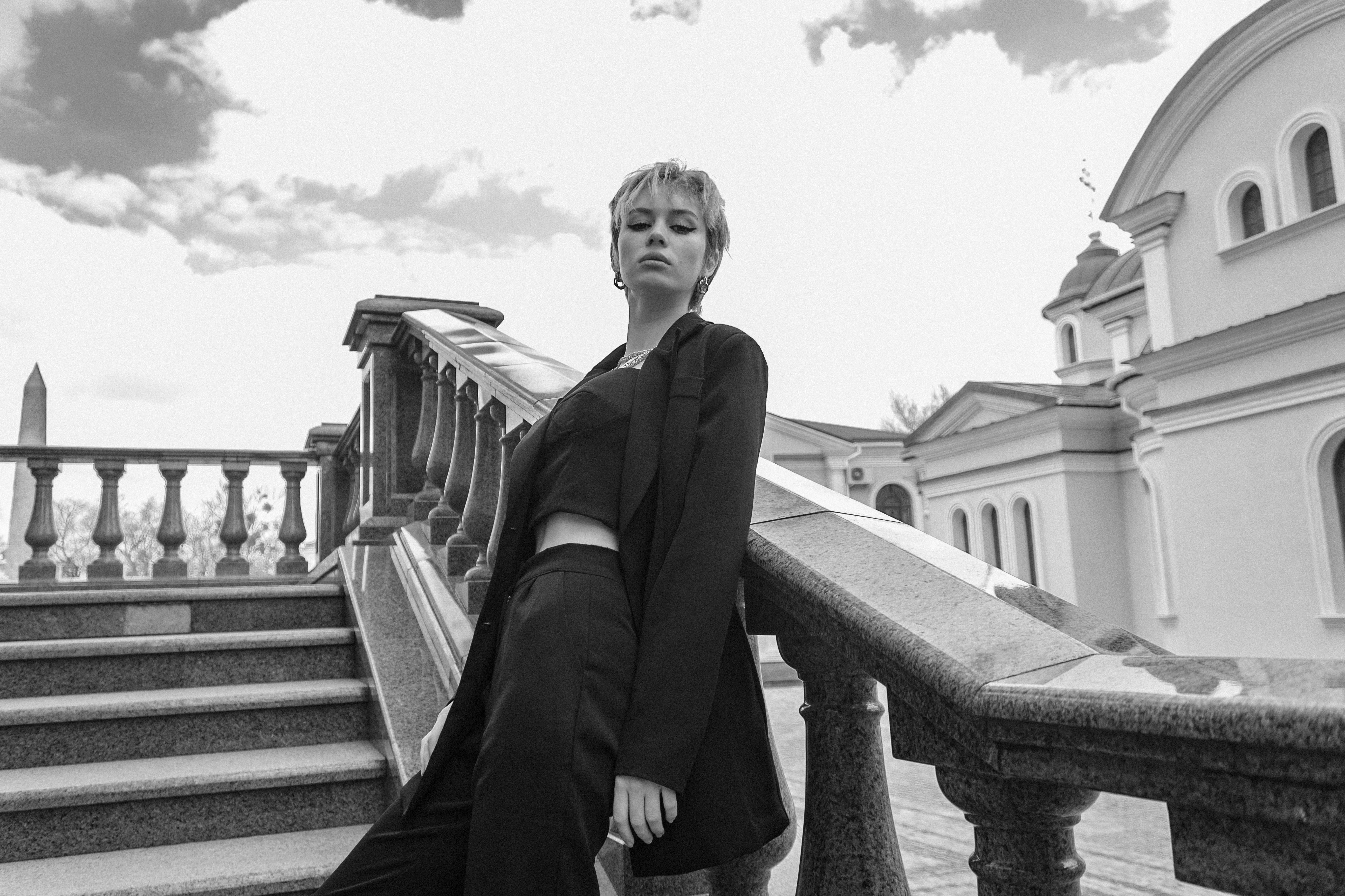 Woman in Black Coat Standing on Staircase · Free Stock Photo