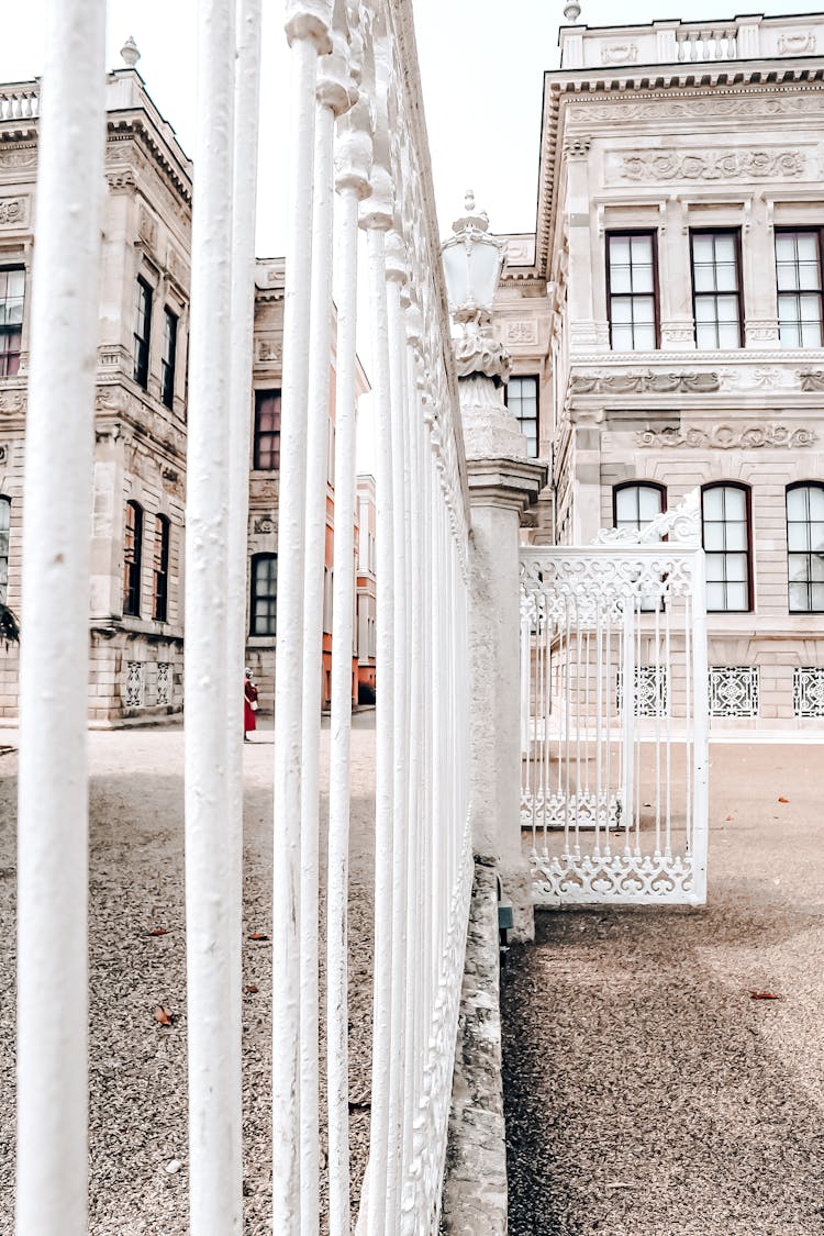 White Fence In Front Of Classical Building 