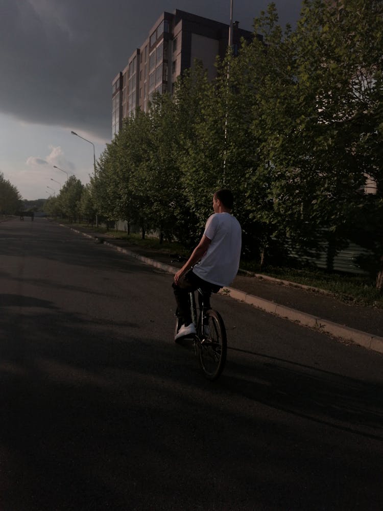 Guy Riding Bike On City Street