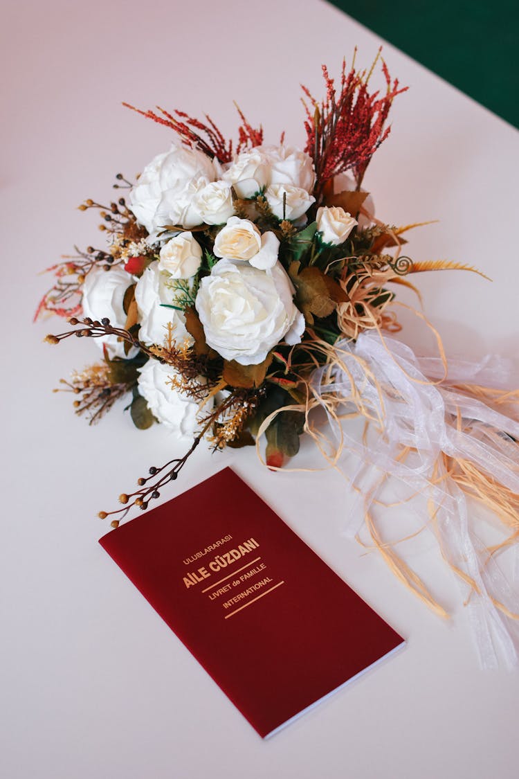 Flowers And Marriage Certificate On Table