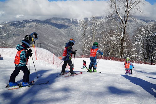 Children Skiing on the Mountain Slope Covered in Snow