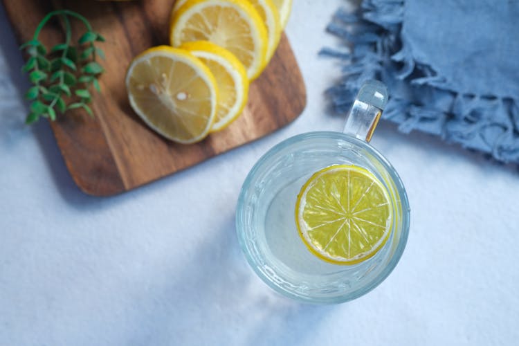 
A Cup Of Water With A Slice Of Lemon