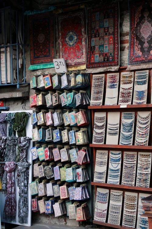 Free Vibrant street market stall featuring colorful jewelry and fabric accessories in an outdoor setting. Stock Photo