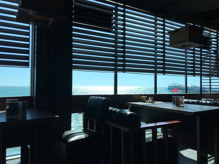 
A View Of The Ocean From Inside A Restaurant