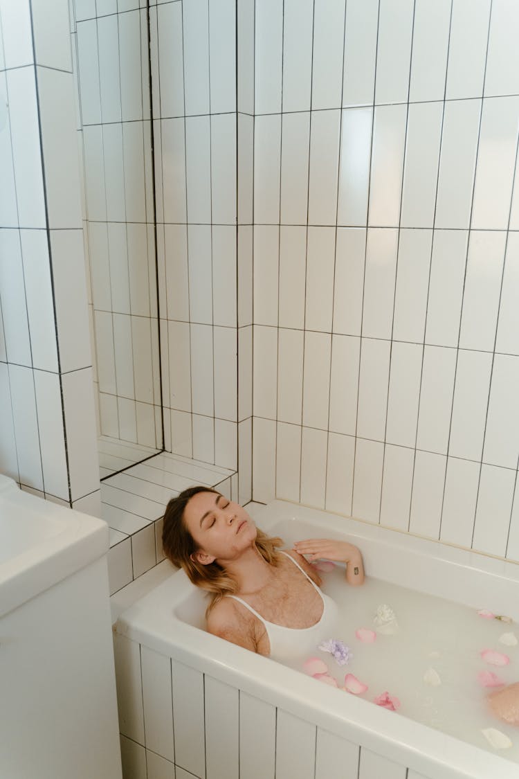 A Woman Resting On A Bath Tub