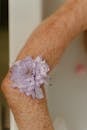 White and Purple Flower on Persons Wrist