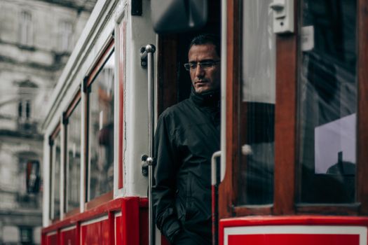Man in Black Jacket Standing in Train