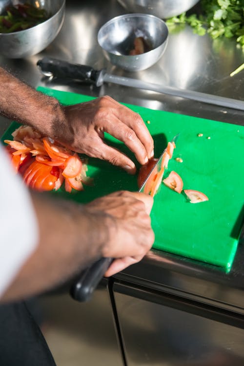 A Person Slicing Tomatoes