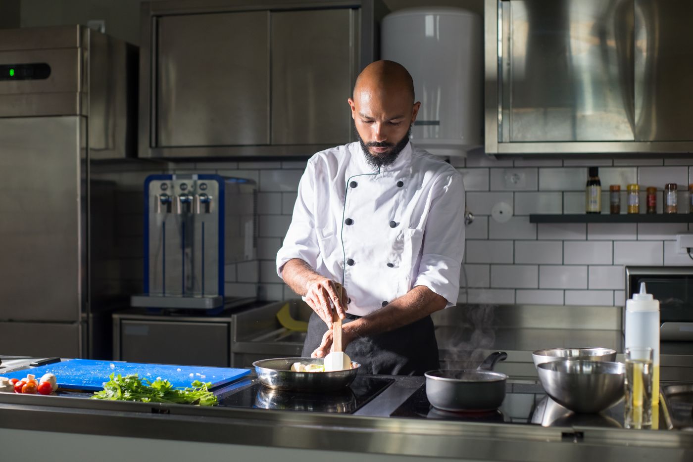 A chef plating an order for a delivery-first kitchen