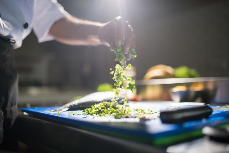 Chef preparing fresh seasonal ingredients in the Grounded Coffee Co. kitchen
